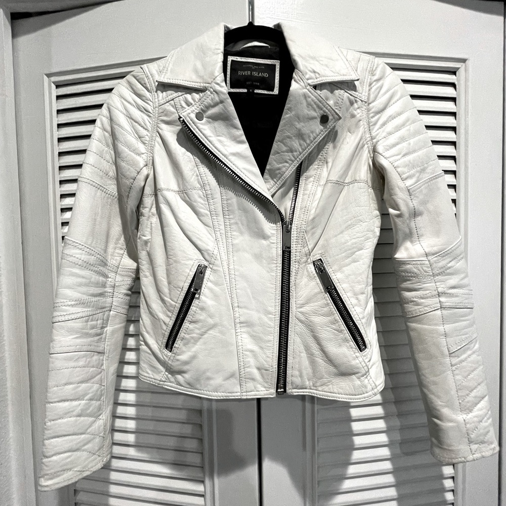 White leather jacket with black zip detail